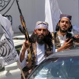 Des Afghans brandissent des drapeaux de l'Emirat islamique d'Afghanistan à l'occasion du deuxième anniversaire de la prise de contrôle du gouvernement afghan par les talibans, à Kaboul mardi.